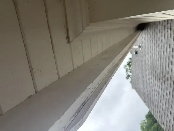White soffit and fascia with visible mildew and oxidation before house washing service in Marietta, GA