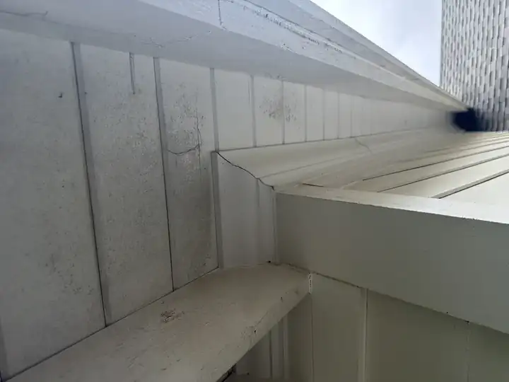 White vinyl soffit with heavy mildew and dirt buildup before house washing in Marietta, GA