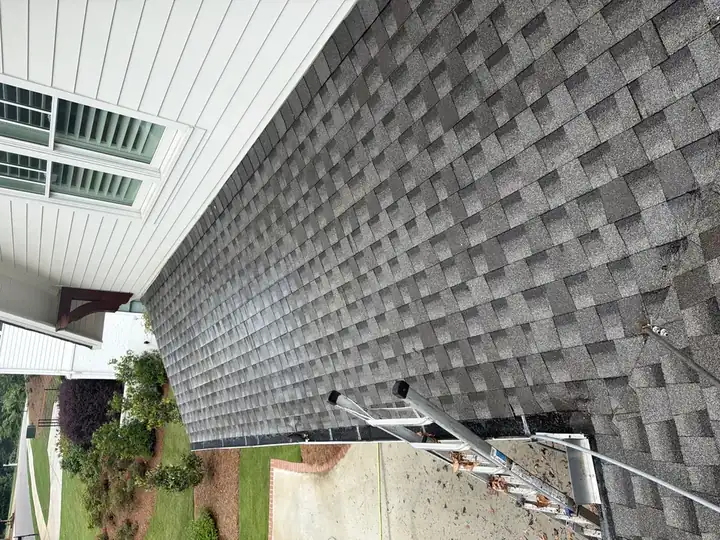Clean asphalt shingle roof slope after soft wash cleaning on a residential home in Marietta, GA