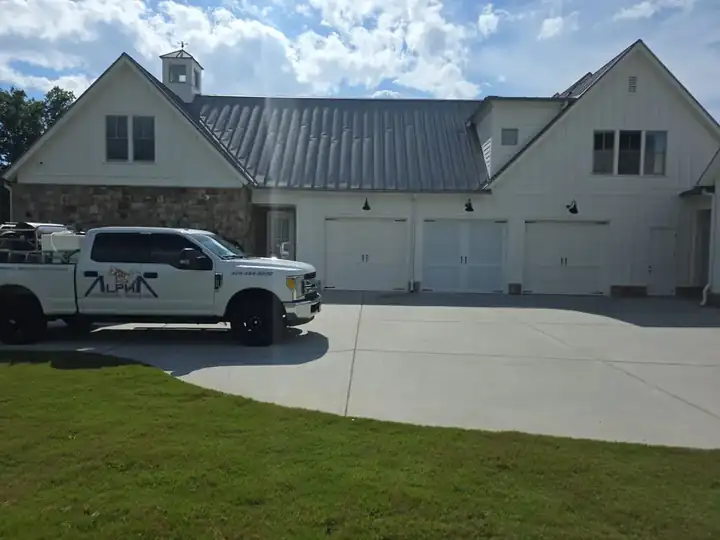 Alpha Pressure Washing truck parked in front of a white board-and-batten farmhouse garage in Milton, GA.