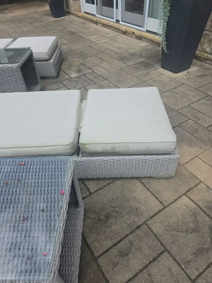 Outdoor wicker furniture on a stamped concrete patio at a Milton, GA residence during a pressure washing visit.