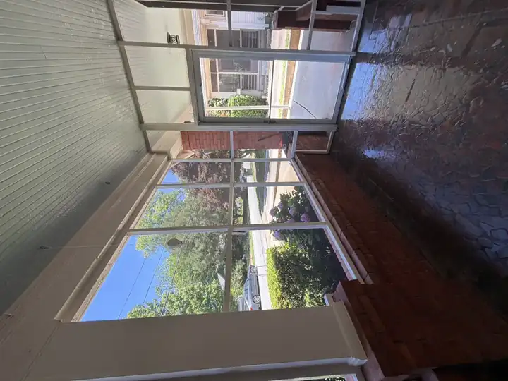 Screened porch mosaic floor glistening clean after pressure washing at a home in East Point, GA