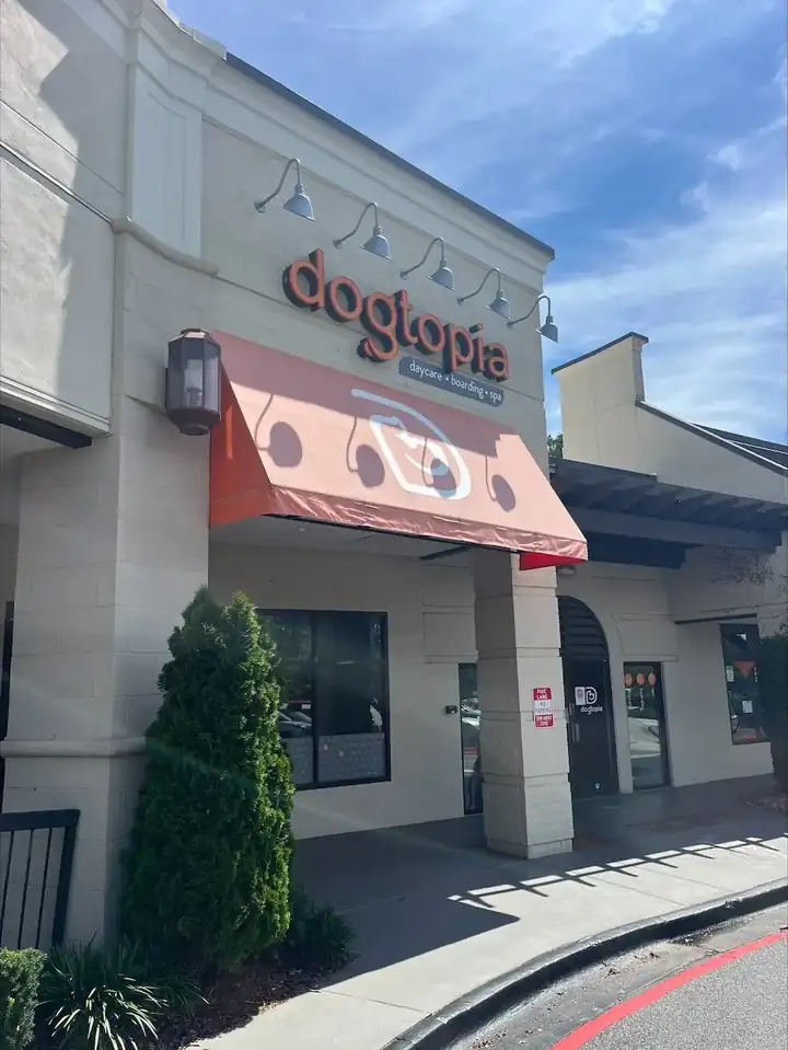 Commercial storefront awning at a pressure washing job in Roswell, GA, viewed from street level on a sunny day.