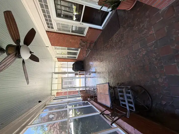 Screened porch mosaic brick floor freshly washed and wet with patio seating in East Point, GA