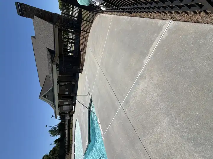 Concrete pool deck in front of community clubhouse after pressure washing in Canton, GA, wide clean view