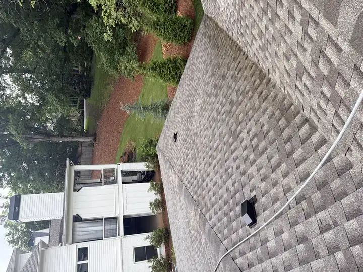 Clean asphalt shingle roof after soft wash service on a large residential home in Marietta, GA