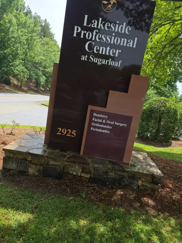 Commercial monument sign on a stone base at a soft wash job in Duluth, GA, sign panels appearing clean in bright daylight.