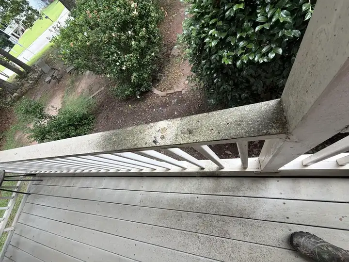 Concrete porch railing cap with heavy mildew and algae growth on a residential home in Canton, GA before pressure washing