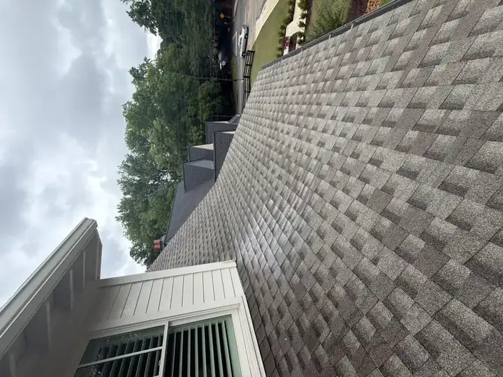 Freshly cleaned asphalt shingle roof on residential home in Marietta, GA showing full slope after service