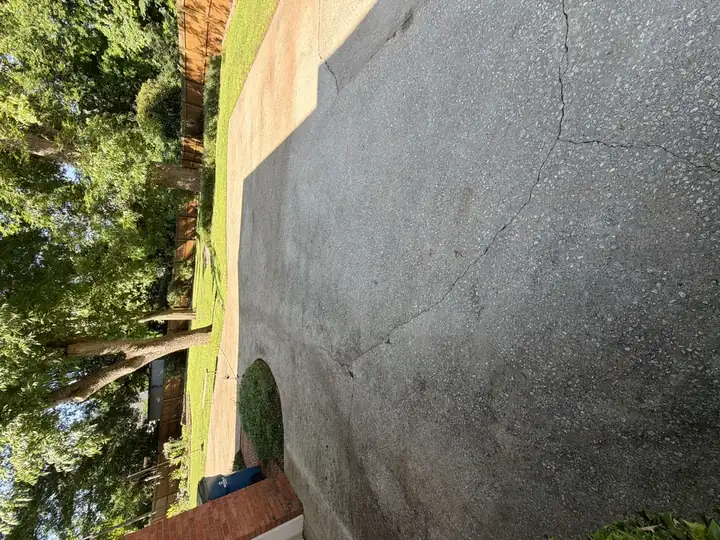 Dirty concrete driveway pad with grime and discoloration before pressure washing in East Point, GA